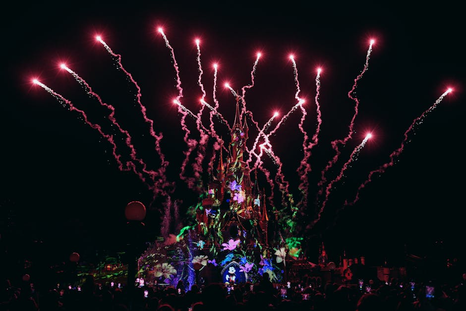 Shanghai Disneyland Enchanted Storybook Castle illuminated at night with fireworks