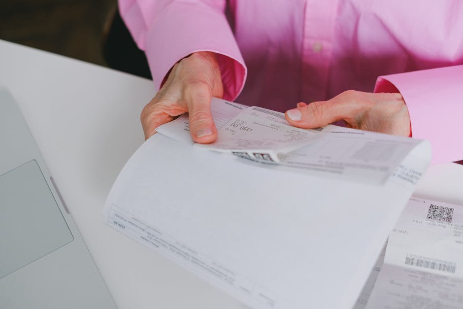 A close-up of a person holding an official Chinese Fapiao tax invoice.