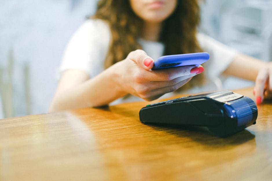 Close up of a person using WeChat Pay on a smartphone in a restaurant