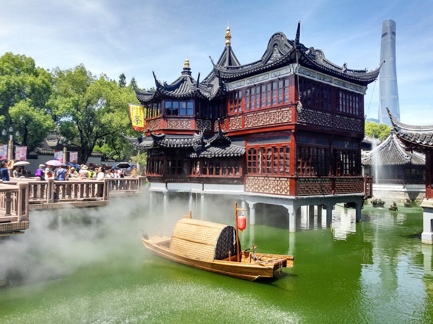 Huxinting Teahouse sitting on the water in Yuyuan Garden during a rainy day