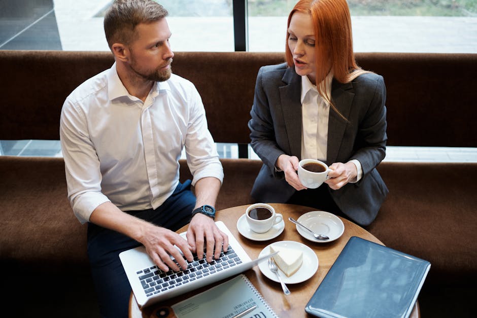 Professionals working in a Shanghai cafe, discussing finances over coffee