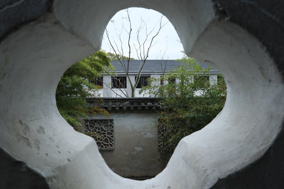 Traditional Chinese garden architecture framing a view of nature