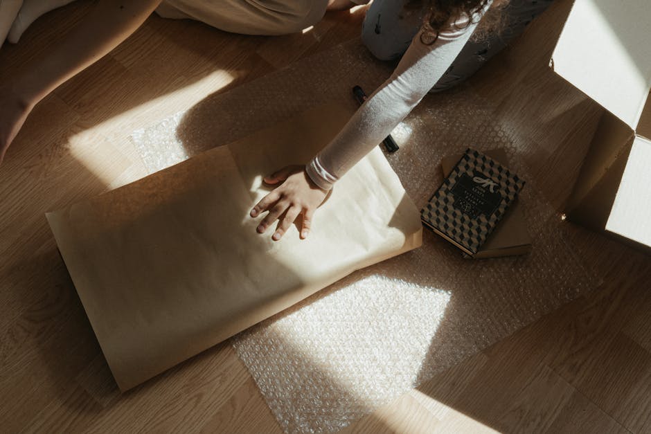 Carefully packing a vintage Chinese tea set with bubble wrap